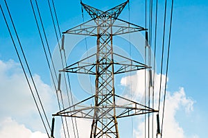 The High voltage transmission lines isolated on blue sky background