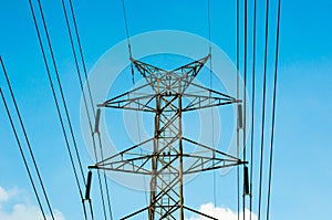 The High voltage transmission lines isolated on blue sky background