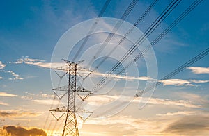 High voltage transmission lines on orange and blue sky, sunrise