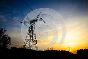 High-voltage transmission power towers silhouette