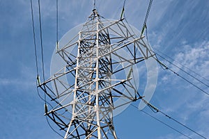 High Voltage Transmission Tower Against Blue Sky photo