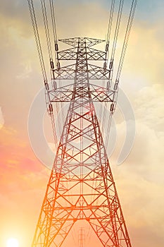 High voltage transmission tower with golden sky background at twiligh time photo