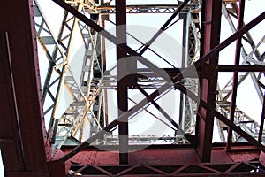 High voltage transmission tower line against blue sky, bottom view. iron construction.