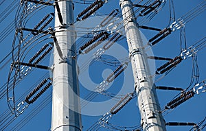 High-voltage transmission towers against blue sky