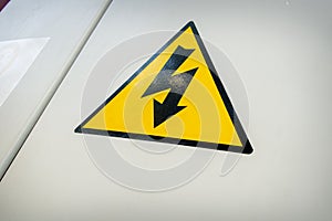 High voltage triangle warning sign mounted