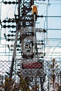 power line structure with caution sign photo
