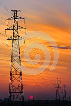 High-voltage wire tower, sunset