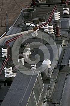 High voltage wires on ceramic insulators above a transformer station