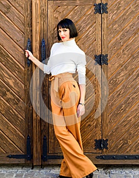 High waisted pants fashion trend. High waisted trousers. Woman attractive brunette wear fashionable clothes. Femininity