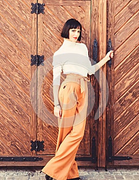 High waisted pants fashion trend. High waisted trousers. Woman attractive brunette wear fashionable clothes. Femininity