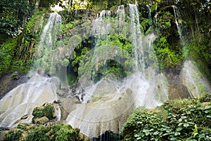 High waterfall in a jungle with water splashing over rocks, Cuba