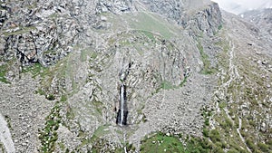 High waterfall among the rocks. View from a drone.