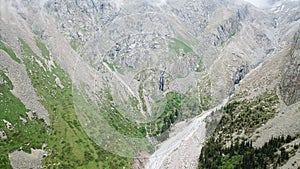 High waterfall among the rocks. View from a drone.