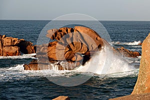 High waves at Pink Granite rock coast in Brittany