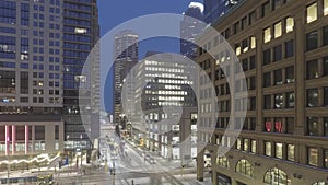 A high wide angle long exposure of bus and lightrail train traffic and station in downtown Minneapolis during a winter twilight 4k