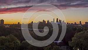 A high wide angle long exposure of traffic on I94 Cutting Through Minneapolis during a Dramatic Autumn Sunset 4K UHD Timelapse