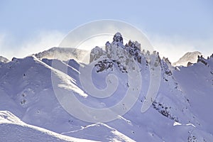 High winds blowing snow off mountain range RosszÃÂ¤hne  denti di terrarossa at Alp photo