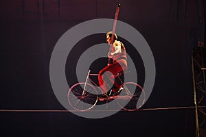 High wire circus act with bike