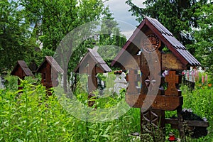 High wooden crosses in the graveyard of The Church of the Holy Archangels in Rogoz village, Maramures County, Romania, Europe.