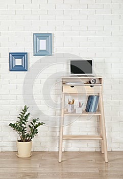 High wooden table with laptop as stand up workplace