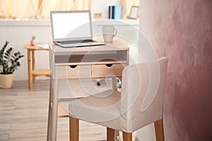 High wooden table with laptop as stand up workplace