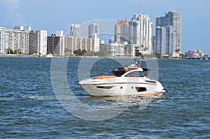 Highend Cabin Cruiser Idling off of Miami Beach photo