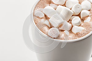 Highest quality. Top view of Hot cacao with marshmallow on top in white ceramic mug. White background. Best for commercial