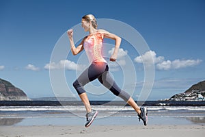 Highlighted back bones of jogging woman on beach