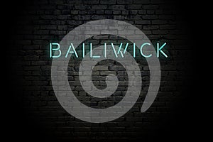 Highlighted brick wall with neon inscription bailiwick photo