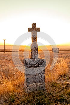 Highlighted cross memorial monument along the side of the road