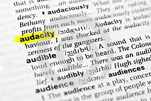 Highlighted English word `audacity` and its definition in the dictionary photo