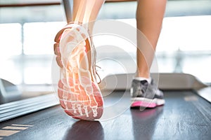 Highlighted foot of woman on treadmill