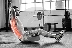 Highlighted spine of exercising man at gym