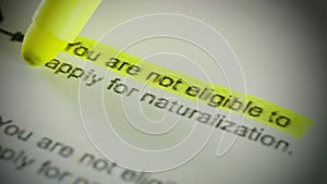A highlighter marks `you are not eligible for naturalization` on a document