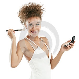 Highlighting the beauty she was blessed with. Studio shot of an attractive young woman applying makeup to her face