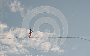 Highliner walks on a tightrope against the backdrop of the firmament photo