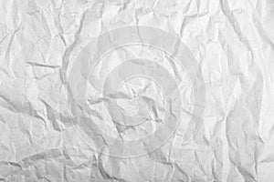 highly crumpled gray paper sheet with dents Close up