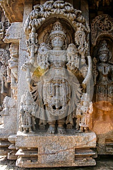 Highly detailed intrinsic carvings of deity with ornaments at Somnathpur, Karnataka, India photo