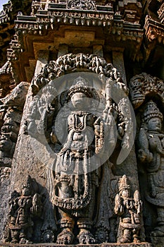 Highly detailed intrinsic carvings of deity with ornaments at Somnathpur, Karnataka, India. photo