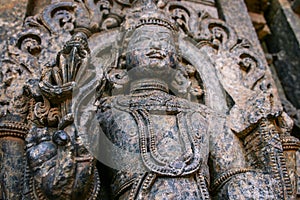 Highly detailed intrinsic carvings of deity with ornaments at Somnathpur, Karnataka, India. photo