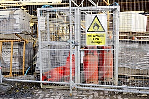Highly flammable gas propane cylinders store cage for safety near construction building site and the public protection photo