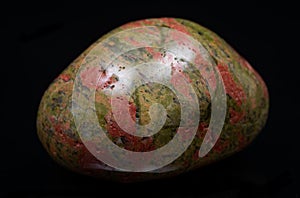 Highly polished puffy Unakite specimen from Unakas Mountains in North Carolina, on black background