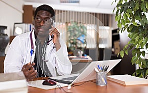 Highly qualified african american doctor conducts a patient consultation on a mobile phone