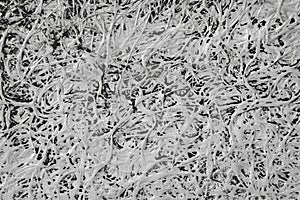 a highly textured surface with a chaotic, tangled pattern.