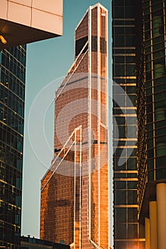 Highrise building against clear morning sky background. low angle view of office building in business center. Modern glass