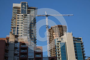 Highrise buildings construction crane blue sky
