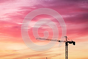 Highrise tower crane over sunset