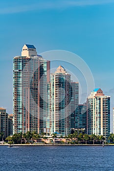 Highrise towers in Aventura Florida pink building on blue sky and water photo