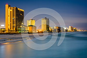 Highrises along the Gulf of Mexico at night, in Panama City Beach, Florida photo