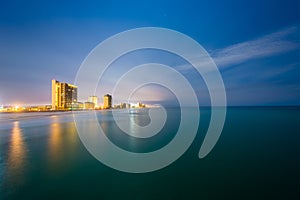 Highrises along the Gulf of Mexico at night, in Panama City Beach, Florida photo